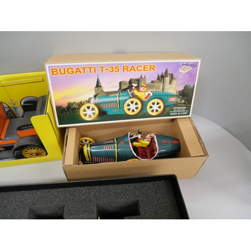 688 - A Schuco Old Timer tinplate car, a Chinese vintage Shanghai tram, Bugatti racer, all boxed and one o... 