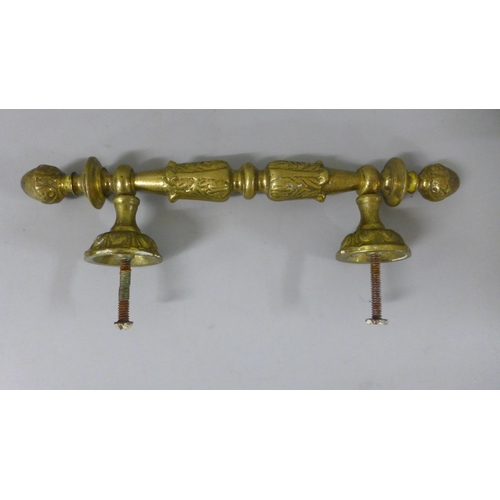 797 - A pair of brass bath taps and a pair of brass door handles and trim