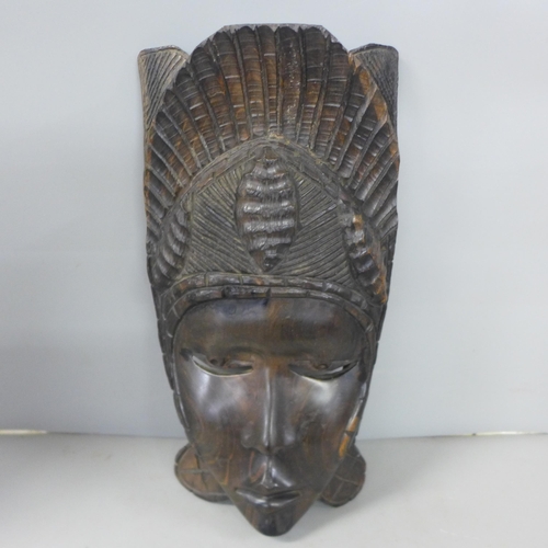 811 - An African hand carved hardwood tribal mask, 38cm, a hand carved pair of hardwood African busts, 16c... 