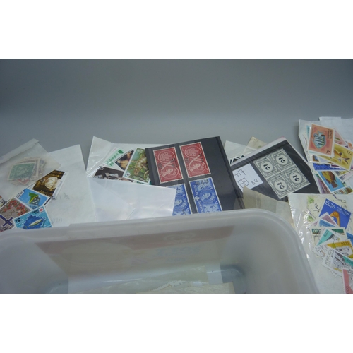 831 - A tub of stamps in packets and on stockcards with values