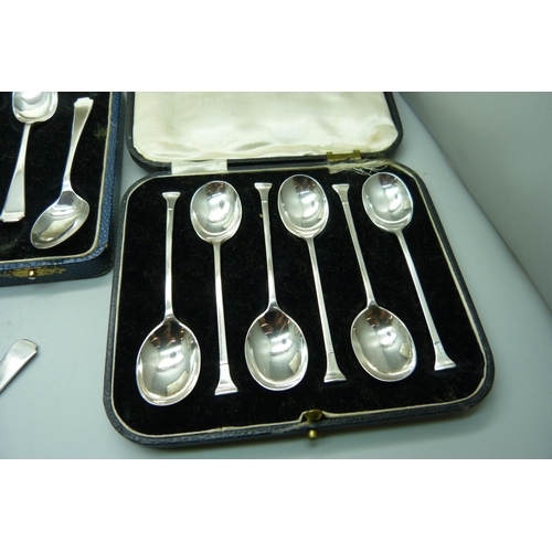 865 - Three cased sets of silver spoons, 162g, (one pair of sugar bows plated, one associated box, one spo... 