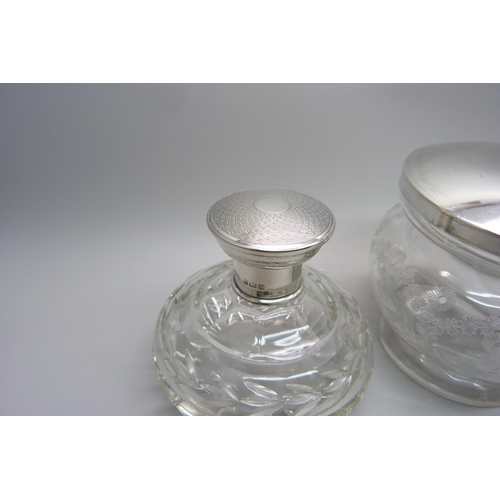 920 - A silver topped glass preserve jar, a silver topped scent bottle and a silver topped jar with mirror... 