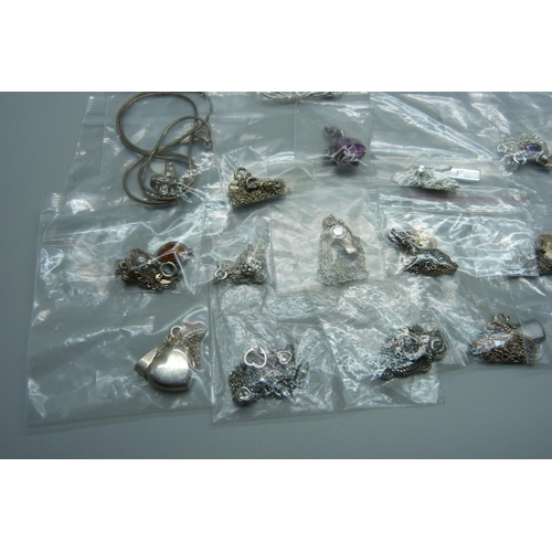 930 - A collection of silver pendants and chains