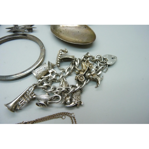 948 - A silver charm bracelet, bangle, pendants and chains, etc.