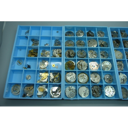 950 - A collection of watch movements and watch parts, in three trays