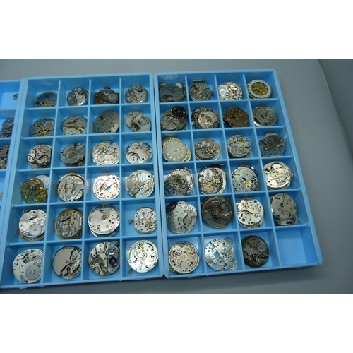 950 - A collection of watch movements and watch parts, in three trays