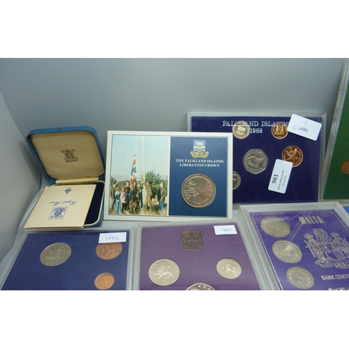 957 - A collection of coins, coin covers and a stamp cover, including two £5 coins, coin sets, etc.