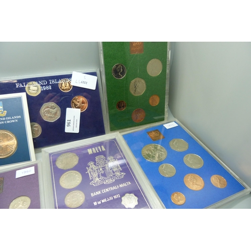 957 - A collection of coins, coin covers and a stamp cover, including two £5 coins, coin sets, etc.