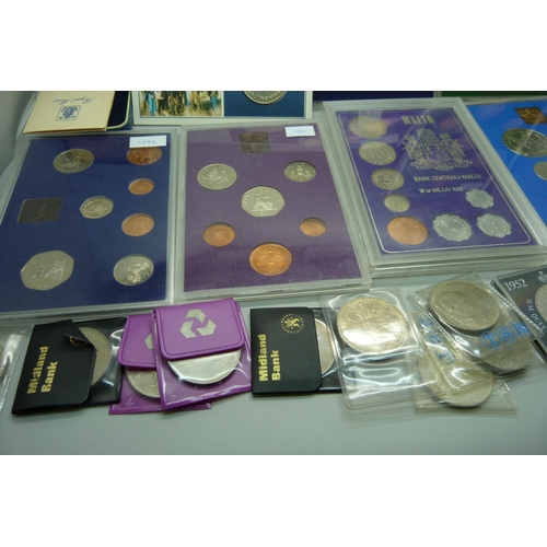 957 - A collection of coins, coin covers and a stamp cover, including two £5 coins, coin sets, etc.