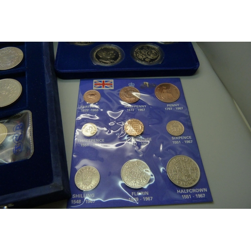 957 - A collection of coins, coin covers and a stamp cover, including two £5 coins, coin sets, etc.