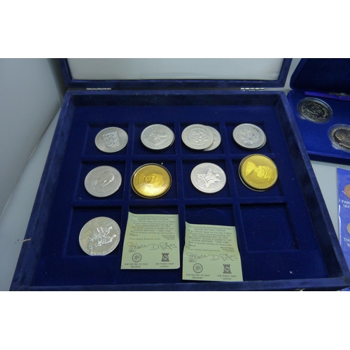 957 - A collection of coins, coin covers and a stamp cover, including two £5 coins, coin sets, etc.