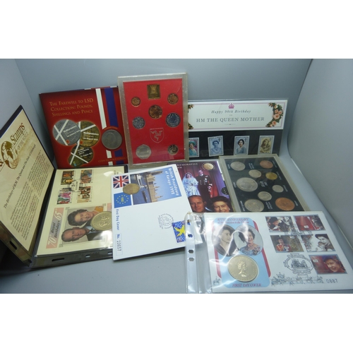 957 - A collection of coins, coin covers and a stamp cover, including two £5 coins, coin sets, etc.