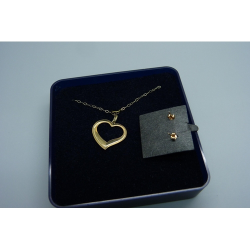 965 - A 9ct gold heart pendant on a fine 9ct gold chain, together with a pair of yellow metal earrings