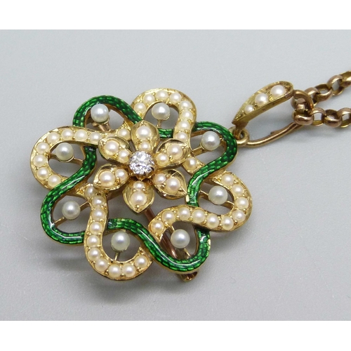 969 - A yellow metal pendant with guilloche green enamel border, half seed pearls and a central diamond, o... 