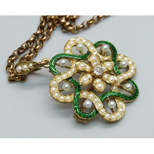 969 - A yellow metal pendant with guilloche green enamel border, half seed pearls and a central diamond, o... 