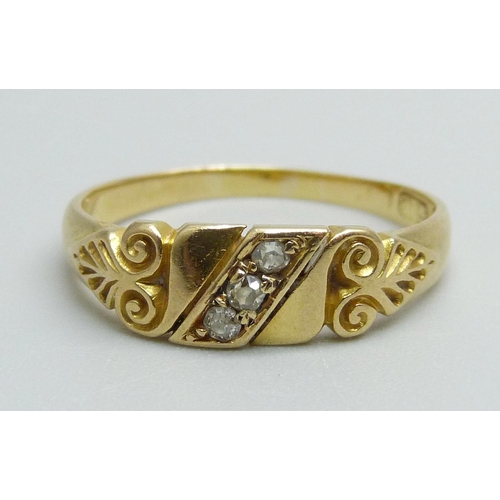 972 - An 18ct gold scroll design three stone diamond ring, 3.6g, R