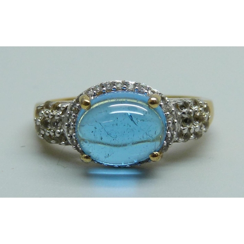 982 - A silver gilt blue cabochon and white stone ring, S