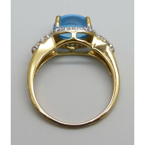 982 - A silver gilt blue cabochon and white stone ring, S