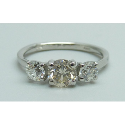 989 - A hallmarked platinum three stone diamond ring, total diamond weight 1.30 carats, (centre stone 0.75... 