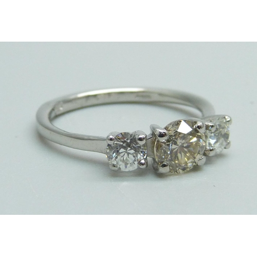 989 - A hallmarked platinum three stone diamond ring, total diamond weight 1.30 carats, (centre stone 0.75... 