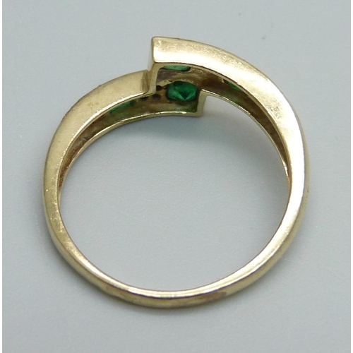 999 - A 9ct gold, emerald and diamond set ring, 2.6g, O