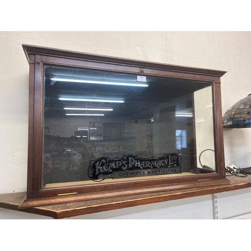 378 - A mahogany shop display cabinet, bearing Kemps Pharmacy Ltd. inscription