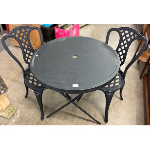 273 - A cast alloy garden table and chairs