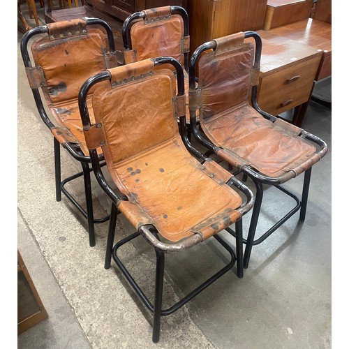 94 - A set of four Les Arc style black tubular metal and brown leather chairs, manner of Charlotte Perria... 