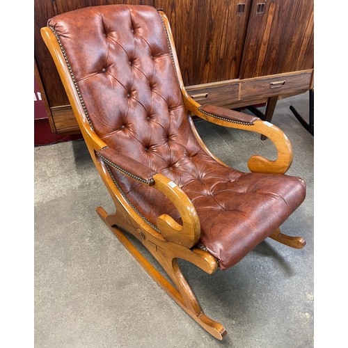 97 - A Regency style mahogany and chestnut brown leather rocking chair
