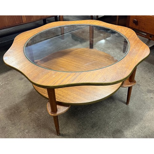 78 - A teak and glass topped circular coffee table