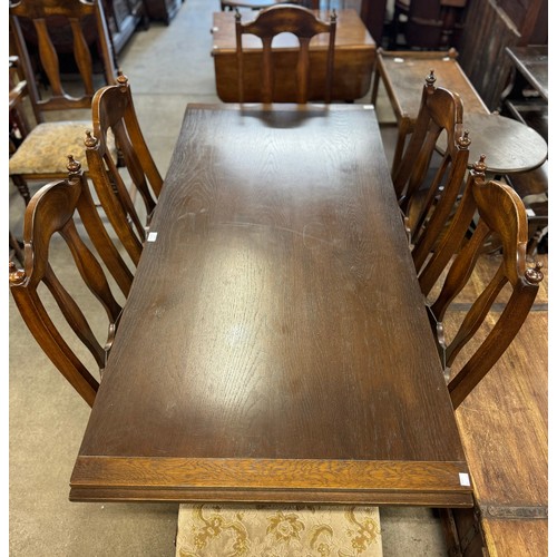 196 - An oak refectory table and eight chairs