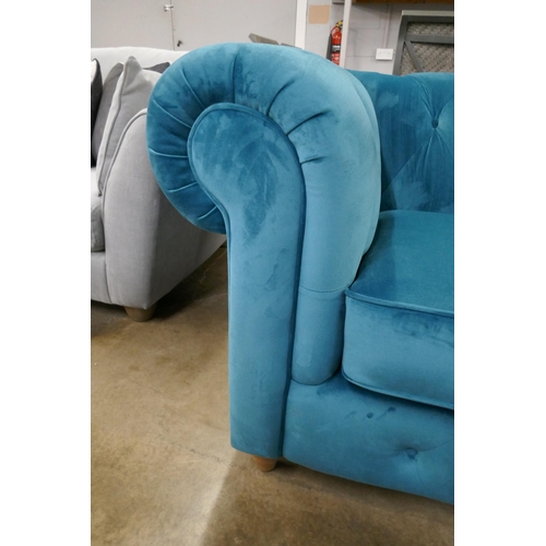1445 - A turquoise velvet Chesterfield love seat RRP £1129
