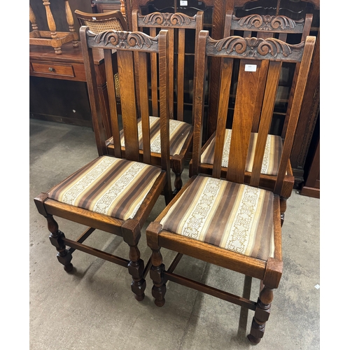 205 - A set of four early 20th Century carved oak dining chairs