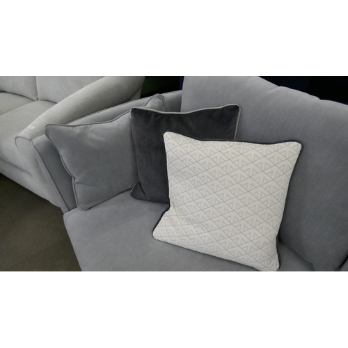 1499 - A grey velvet three seater sofa