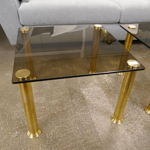 1501 - A square occaisional table with a solid brass base and a smoked tempered glass top