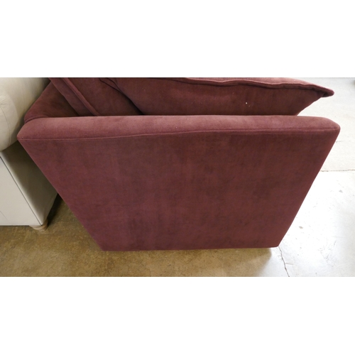 1507 - A burgundy velvet three seater sofa