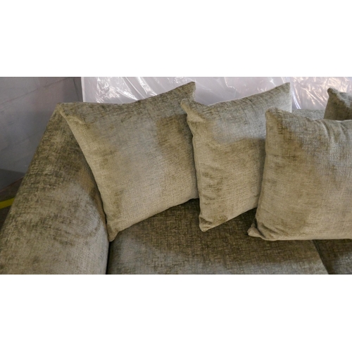 1520 - A green velvet three seater sofa