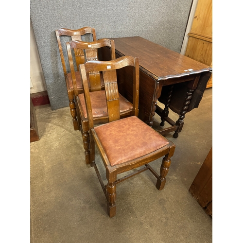215 - An early 20th Century oak barleytwist gateleg table and three chairs