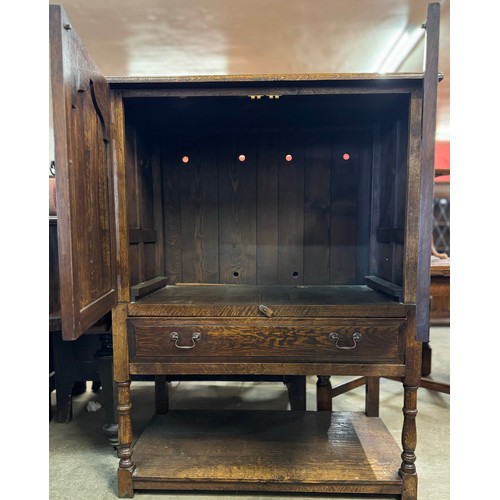 227 - A George III style Ipswich oak cupboard on stand
