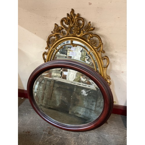 392 - A walnut oval mirror and a gilt framed mirror