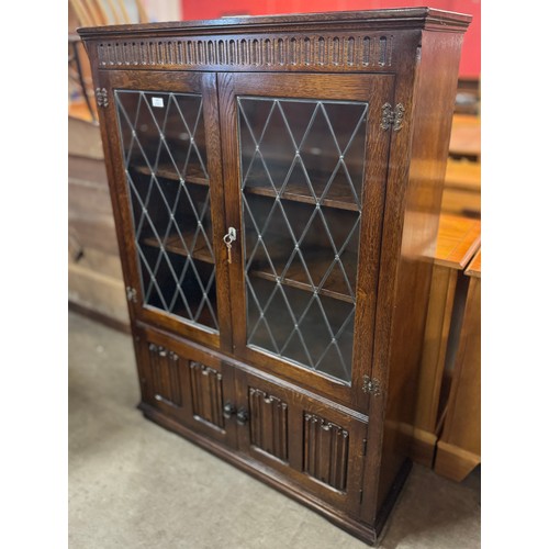 163 - A carved oak four door bookcase