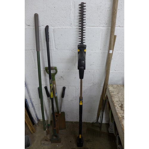 2214 - A bundle of garden tools including rakes, 3 hoes, spades, hedge trimmer, etc.