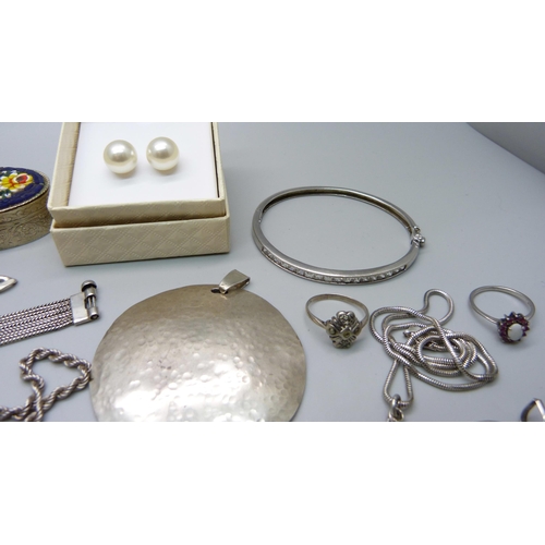 1007 - A collection of silver and white metal jewellery including a silver charm bracelet, chains, pendants... 