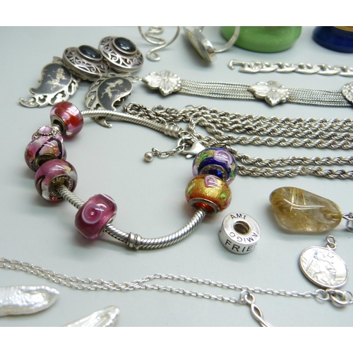 1007 - A collection of silver and white metal jewellery including a silver charm bracelet, chains, pendants... 