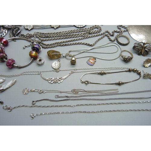 1007 - A collection of silver and white metal jewellery including a silver charm bracelet, chains, pendants... 