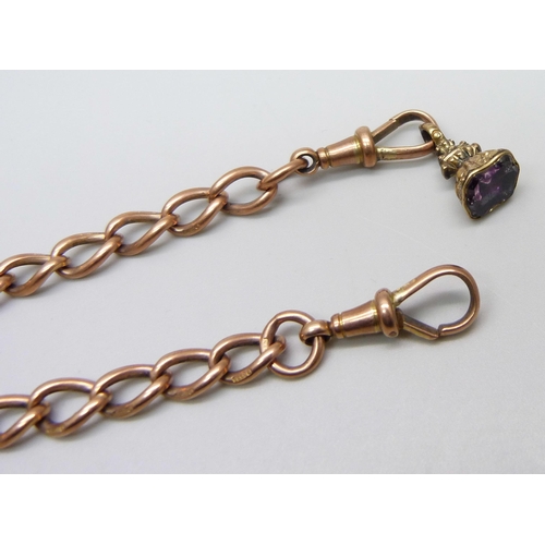 1029 - A 9ct rose gold double Albert chain with a yellow metal fob set with a purple stone, each link marke... 