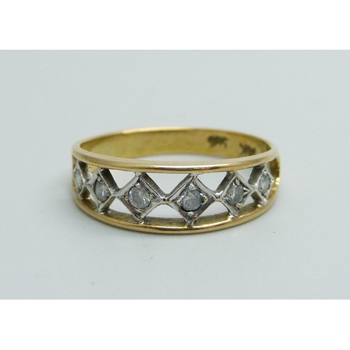1042 - A 14ct gold ring set with six diamonds, 2.1g, L