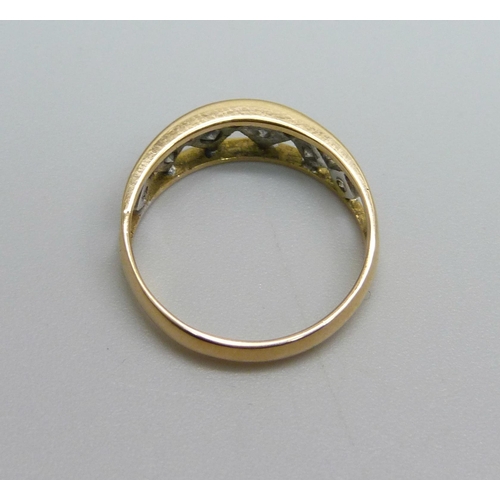 1042 - A 14ct gold ring set with six diamonds, 2.1g, L