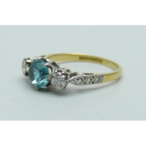 1048 - An 18ct gold and platinum set ring set with two diamonds and a central blue stone, 3.4g, N