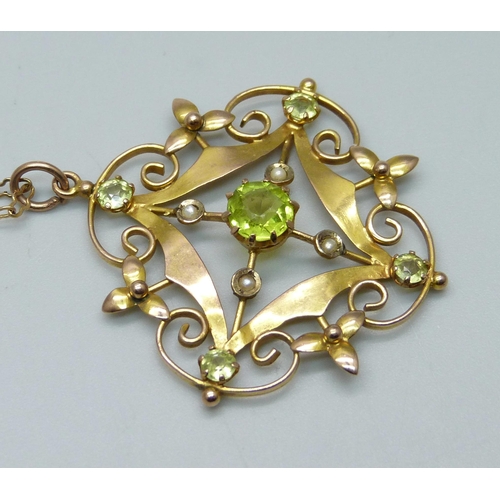 1050 - A 9ct gold pendant set with peridot and half seed pearls on a 9ct gold chain, 5.1g, 36cm